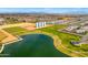 Panoramic aerial view featuring a community lake with recreational areas, surrounded by lush green spaces and residential houses at 3548 E Mesquite St, Gilbert, AZ 85296