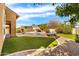 Backyard pool with lush grass, rock border, and artificial turf at 3548 E Mesquite St, Gilbert, AZ 85296