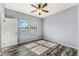 Bedroom with hardwood floors, a ceiling fan, and two windows at 3548 E Mesquite St, Gilbert, AZ 85296