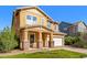 Inviting two-story house with a well-manicured lawn, a two-car garage, and a charming front porch with stone accents at 3548 E Mesquite St, Gilbert, AZ 85296