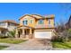 Attractive two-story home featuring a brick driveway, a two-car garage, and a welcoming front porch with decorative pillars at 3548 E Mesquite St, Gilbert, AZ 85296