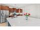 Bright kitchen featuring stainless steel appliances, wood cabinets, and a large island with white countertop at 3548 E Mesquite St, Gilbert, AZ 85296