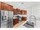 Well-equipped kitchen featuring wood cabinets, stainless steel appliances, and a white countertop island at 3548 E Mesquite St, Gilbert, AZ 85296