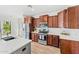 Modern kitchen featuring stainless steel appliances, wood cabinetry, and a bright countertop island at 3548 E Mesquite St, Gilbert, AZ 85296