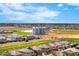 Aerial view of a residential neighborhood with a pond and silos in the background at 3548 E Mesquite St, Gilbert, AZ 85296