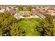 Aerial view of a well-maintained neighborhood park with a large grassy area and mature trees at 3548 E Mesquite St, Gilbert, AZ 85296