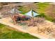 Close aerial view of a neighborhood playground featuring swings, slides, and covered play areas at 3548 E Mesquite St, Gilbert, AZ 85296