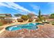 Swimming pool view showing the rock border, lush grass, and lounge chairs at 3548 E Mesquite St, Gilbert, AZ 85296