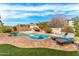 Backyard pool with lounge chairs, lush landscaping, and clear blue water at 3548 E Mesquite St, Gilbert, AZ 85296