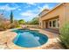 Backyard pool with lounge chairs and lush landscaping surrounding it at 3548 E Mesquite St, Gilbert, AZ 85296