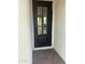 A stylish black front door with glass panes adds elegance to this home's entrance at 3646 E Roland St, Mesa, AZ 85215