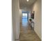 Bright hallway featuring sleek floors, modern decor, and an open view of the living space at 3646 E Roland St, Mesa, AZ 85215