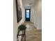 Hallway featuring sleek floors, modern decor, and a black front door with glass panes at 3646 E Roland St, Mesa, AZ 85215