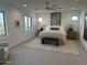 Spacious bedroom with neutral tones, a large window, and an elegant ceiling fan at 3646 E Roland St, Mesa, AZ 85215