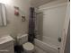 Full bathroom with shower and tub, toilet and sink with mirror at 3932 W Bethany Home Rd, Phoenix, AZ 85019