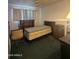 Neutral bedroom with a bed on wheels, cabinets, and bright lighting at 3932 W Bethany Home Rd, Phoenix, AZ 85019