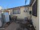 Side of home, showing wall with window, exterior connections and chain link fence at 3932 W Bethany Home Rd, Phoenix, AZ 85019