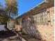 Brick house with barred windows and a tree providing shade on a clear day at 3932 W Bethany Home Rd, Phoenix, AZ 85019