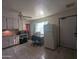 Kitchen featuring tile flooring, a dining table, and ample natural light at 3932 W Bethany Home Rd, Phoenix, AZ 85019