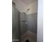 Enclosed shower stall boasts gray and white tile at 3932 W Bethany Home Rd, Phoenix, AZ 85019