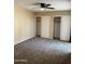 Bedroom with dual sliding door closets, ceiling fan, and neutral carpet at 4107 E Charter Oak N Rd, Phoenix, AZ 85032