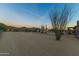 Expansive desert backyard with parking, utility buildings and desert landscaping at dusk at 43611 N 1St Dr, New River, AZ 85087