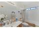 Bright bathroom with a shower-tub combo, single sink vanity and neutral color palette at 43611 N 1St Dr, New River, AZ 85087