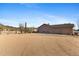 Home exterior showing the expansive parking, garage and desert landscape at 43611 N 1St Dr, New River, AZ 85087