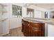 Elegant bar area with granite countertop, wooden cabinetry, and seamless connection to other living spaces at 4485 N 152Nd Dr, Goodyear, AZ 85395