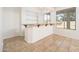 Stylish bar area with open shelving, granite countertops, and natural light from nearby windows at 4485 N 152Nd Dr, Goodyear, AZ 85395