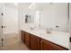 Bathroom with double vanity sinks, a large mirror, and updated fixtures at 4485 N 152Nd Dr, Goodyear, AZ 85395