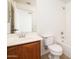 Bathroom with a wood vanity, a sink, a toilet, a mirror, and a shower and bath at 4485 N 152Nd Dr, Goodyear, AZ 85395