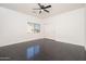 Bright bedroom features wood-look flooring, a ceiling fan, and a view to the outside at 4485 N 152Nd Dr, Goodyear, AZ 85395