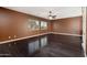 A spacious bedroom featuring dark wood floors, a ceiling fan, and many windows at 4485 N 152Nd Dr, Goodyear, AZ 85395