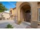 Close up view of a home featuring three car garage and an arched entrance at 4485 N 152Nd Dr, Goodyear, AZ 85395