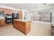 Open kitchen layout with an island, stainless appliances, and seamless flow to the living area at 4485 N 152Nd Dr, Goodyear, AZ 85395