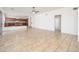 Open living space featuring tile floors, a ceiling fan, and a bar area leading to the kitchen at 4485 N 152Nd Dr, Goodyear, AZ 85395