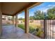 Covered patio with textured concrete overlooks a spacious yard with a privacy fence at 4485 N 152Nd Dr, Goodyear, AZ 85395