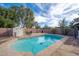 Backyard pool includes a storage shed, table, chairs, barbecue and palm trees at 4485 N 152Nd Dr, Goodyear, AZ 85395