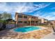 Backyard pool and patio area features stone pavers, gazebo and well maintained two story house at 4485 N 152Nd Dr, Goodyear, AZ 85395