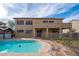 Beautiful backyard pool area complete with covered patio, stone pavers, and lush green landscaping at 4485 N 152Nd Dr, Goodyear, AZ 85395