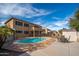 Backyard view featuring a sparkling pool, patio space, lush landscaping and house exterior at 4485 N 152Nd Dr, Goodyear, AZ 85395