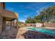 Inviting pool featuring flagstone patio, lush trees, privacy fence, and storage shed on a sunny day at 4485 N 152Nd Dr, Goodyear, AZ 85395