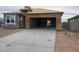 A home under construction featuring a spacious driveway and a modern architectural design with ample garage space at 469 W Freedom St, Florence, AZ 85132