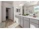 Bright bathroom with double sinks, modern cabinetry, and a tiled backsplash at 5325 N 188Th Ave, Litchfield Park, AZ 85340