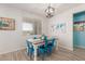 Cozy dining area with a modern table and bright chairs, adjacent to the kitchen at 5325 N 188Th Ave, Litchfield Park, AZ 85340