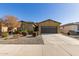 Inviting single-story home with a well-manicured xeriscaped front yard and covered entryway at 5325 N 188Th Ave, Litchfield Park, AZ 85340