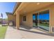 Covered patio area with space for grilling and relaxing, overlooking the backyard at 5325 N 188Th Ave, Litchfield Park, AZ 85340