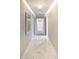 Bright hallway with white marble floors leading to double doors framed by a large decorative mirror at 5819 E Calle Del Media --, Phoenix, AZ 85018