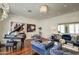 Elegant living room featuring blue velvet sofas, hardwood floors, piano, and modern art under a chandelier at 5819 E Calle Del Media --, Phoenix, AZ 85018